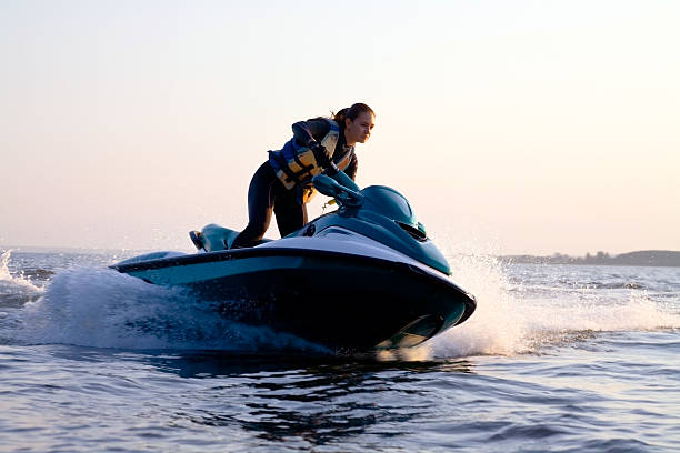 female jet skiing in cold weather wearing dry suit