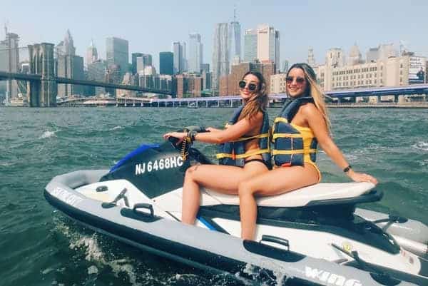 2 women riding a jet ski in the Hudson River