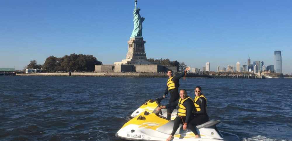 3 people on jet skis wearing life jackets